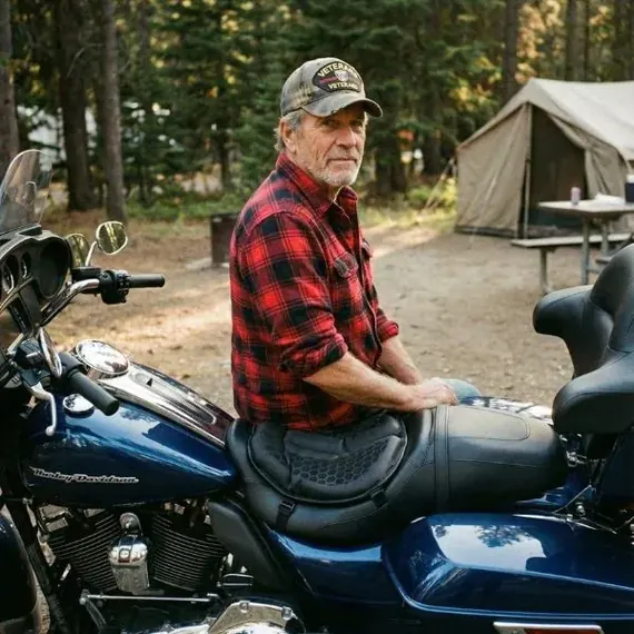Rob P. sitting on his SelleZen-equipped Harley at the campsite
